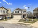 Charming two-story home featuring a brick facade, attached garage and well-maintained landscaping at 789 Galveston Way, Mcdonough, GA 30253