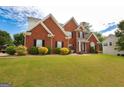 Inviting two-story brick home with well-maintained lawn and colorful shrubbery at 208 Summer Chase, Carrollton, GA 30116