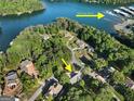 An aerial view shows the property's proximity to Bald Ridge Marina, nestled amidst lush greenery near a lake at 1875 Bernice Dr, Cumming, GA 30041