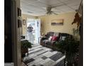 Cozy living room with patterned rug, ceiling fan, and a comfortable couch, filled with lots of plants at 2195 Wilson Nw Rd, Conyers, GA 30012