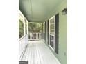 Inviting porch with white railings, offering a view of the surrounding trees and natural light at 305 Glenloch Ln, Stockbridge, GA 30281