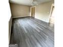 Spacious living room featuring new gray flooring, neutral walls, and ample natural light at 229 Timberland Trl, Riverdale, GA 30274