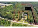 Expansive aerial view of the property's acreage, showcasing the home's setting amidst lush greenery at 3499 S Ola Rd, Locust Grove, GA 30248