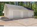 Detached three-car garage offering ample parking and storage space with a concrete driveway at 3499 S Ola Rd, Locust Grove, GA 30248