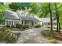 Inviting home with a charming covered porch, well-manicured landscaping, and a circular driveway at 2058 Sewanee Ct, Villa Rica, GA 30180