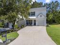 Beautiful two-story home with a spacious driveway and lush green lawn in a suburban setting at 11255 Wittenridge Dr, Alpharetta, GA 30022