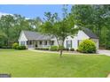 Well-maintained home featuring lush lawn and mature trees, adding curb appeal at 480 Holly Hills Ln, Mcdonough, GA 30252