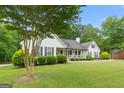 Lovely home with a charming front porch and beautifully landscaped yard at 480 Holly Hills Ln, Mcdonough, GA 30252