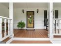 Inviting front porch with decorative wreath and rocking chair for relaxation at 480 Holly Hills Ln, Mcdonough, GA 30252