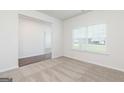 Bright living room with plush carpet and a large window offering plenty of natural light at 279 Oliver Dr, Locust Grove, GA 30248