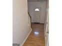 Inviting foyer with hardwood floors, stairs and white front door with window pane details at 547 Se Tufton Se Trl, Atlanta, GA 30354