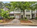 Charming townhome showcasing well-maintained landscaping and attached garages for convenient parking at 547 Se Tufton Se Trl, Atlanta, GA 30354