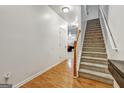 Hallway with hardwood floors leading to carpeted stairs at 547 Se Tufton Se Trl, Atlanta, GA 30354