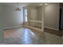 Open-concept living area featuring tile floors, a decorative chandelier and a bright window view at 6260 Marbut Farms Ter, Lithonia, GA 30058