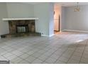 Cozy living room with fireplace, tile flooring, and an open view to the kitchen at 6260 Marbut Farms Ter, Lithonia, GA 30058