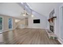 Spacious living room with vaulted ceilings, wood-look flooring, fireplace, and plenty of natural light at 2673 Deerfield Sw Cir, Marietta, GA 30064
