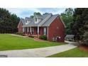 Beautiful home featuring a brick exterior, covered porch and manicured lawn at 1118 Sequoia Trl, Mcdonough, GA 30252