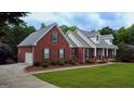 Lovely red brick home with an attached garage and meticulously maintained landscape at 1118 Sequoia Trl, Mcdonough, GA 30252
