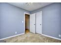 Bedroom with neutral walls, carpet flooring, ceiling fan, and a closet for ample storage at 2066 Tidwell Trl, Stone Mountain, GA 30088