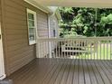 Inviting covered porch featuring a classic porch swing and wood flooring at 1170 5Th Ave, Jonesboro, GA 30236