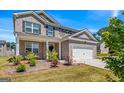 Beautiful two-story brick home featuring an attached two-car garage and professionally landscaped front yard at 600 Dairy Dr, Stockbridge, GA 30281