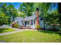 Cozy home featuring a brick chimney, and lush front lawn at 527 W Church St, Villa Rica, GA 30180