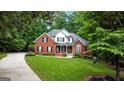 Charming two-story brick home featuring a landscaped front yard and a welcoming entrance at 119 Crown Springs Dr, Mcdonough, GA 30252