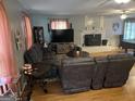 Comfortable living room with hardwood floors, a fireplace, and cozy furniture at 1125 Babbs Mill Rd, Hampton, GA 30228