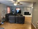 Spacious living room featuring hardwood floors, a fireplace, and a comfortable seating arrangement at 1125 Babbs Mill Rd, Hampton, GA 30228