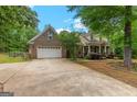 Exterior home view showing a two-car garage and inviting front porch at 2294 Hollonville Rd, Brooks, GA 30205