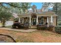 Inviting home exterior with stone porch, walkway, columns, and manicured landscaping at 2294 Hollonville Rd, Brooks, GA 30205