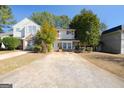Traditional two-story home with a long driveway and mature landscaping, offering curb appeal and outdoor space at 3652 Platina Park Ct, Decatur, GA 30034