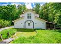 Two-story home with red roof features well-manicured lawn and landscaping at 3258 South Mckoy Rd, Villa Rica, GA 30180