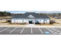 Exterior of community pool house with ample parking and accessible parking spots at 178 Aster, Locust Grove, GA 30248