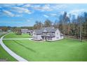 A stately home with an expansive lawn and manicured landscaping at 92 Gordon Oaks Way, Moreland, GA 30259