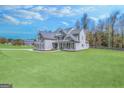 Large, gray, two-story home surrounded by greenery and an extensive lawn at 92 Gordon Oaks Way, Moreland, GA 30259
