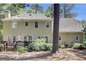 Expansive back exterior features upper and lower windows, deck, grill and beautiful plantings at 121 Tamerlane, Peachtree City, GA 30269