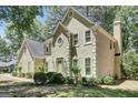 Well-manicured lawn surrounding the home's exterior is visible, complemented by mature trees for added privacy at 121 Tamerlane, Peachtree City, GA 30269