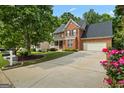 A charming two-story brick home with a well-manicured lawn and inviting front porch at 126 Ardenlee Dr, Peachtree City, GA 30269