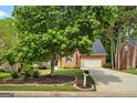 Charming brick home with a manicured lawn and mature tree in a desirable neighborhood at 126 Ardenlee Dr, Peachtree City, GA 30269