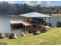 Covered dock with boat slip, offering convenient lake access and waterfront enjoyment at 22 Waters Bridge Cir, Covington, GA 30014