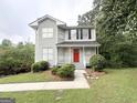 Charming two-story home with a well-manicured front lawn and lush landscaping at 4467 Thornwood Cres, Stone Mountain, GA 30083