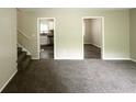 Spacious living room features neutral carpet, and is adjacent to the kitchen and hallway at 815 Magna Carta Nw Dr, Atlanta, GA 30318