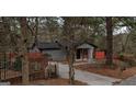 Quaint single-story home with a cozy porch and a red fence surrounding the property at 3479 Thompson Nw Dr, Atlanta, GA 30331