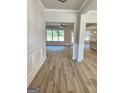 Inviting entryway featuring light wood floors, decorative molding and bright, neutral paint at 1685 Crumbley Rd # 4, Mcdonough, GA 30252