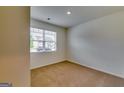 Bright bedroom with neutral carpet, a window with blinds, and fresh paint at 616 Whitman Ln # 30, Stockbridge, GA 30281