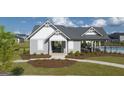 Community clubhouse with a gray exterior, white trim, and manicured landscaping at 616 Whitman Ln # 30, Stockbridge, GA 30281