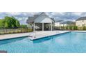 Community swimming pool featuring clear blue water and lounge seating under a sunny sky at 616 Whitman Ln # 30, Stockbridge, GA 30281