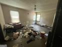 Spacious bedroom with a ceiling fan and two windows, showing potential for renovation and personal touches at 530 Whitley Dr, Forest Park, GA 30297
