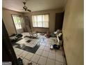 Bright living room featuring checkered floors, a rocking chair, and an open doorway to the exterior at 530 Whitley Dr, Forest Park, GA 30297